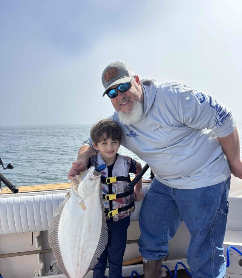 California flounder catch displayed on fishing boat deck over ocean water