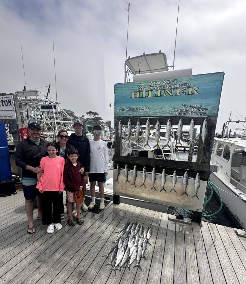 Fishing charter display board showing fresh caught fish at marina dock