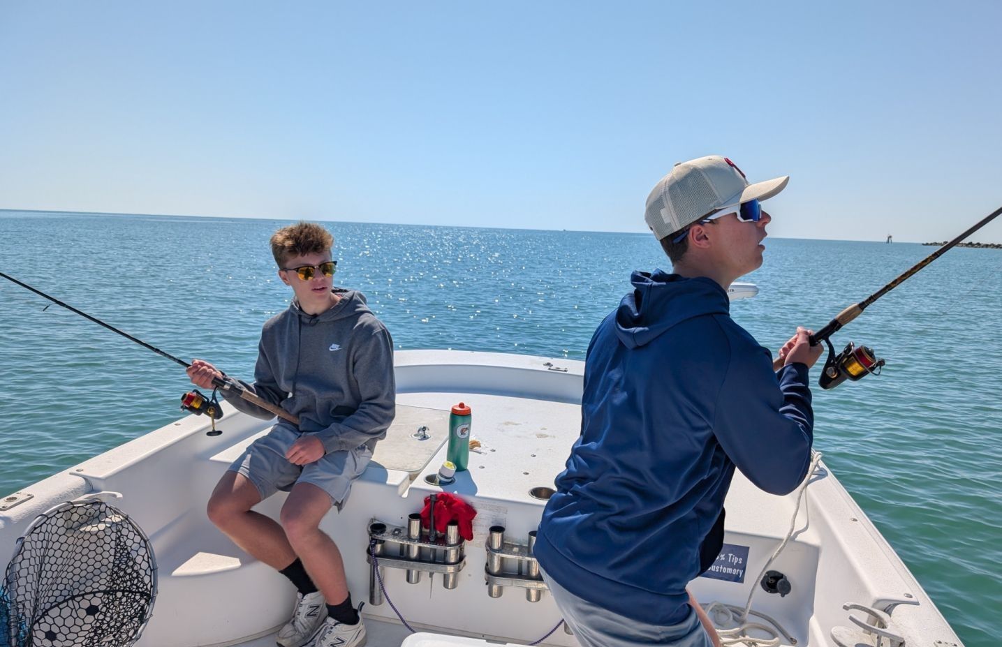 Two people fishing at an unknown location