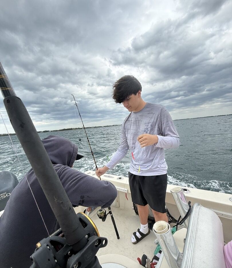 Fishing boat on open water with fishing equipment and rods ready for angling