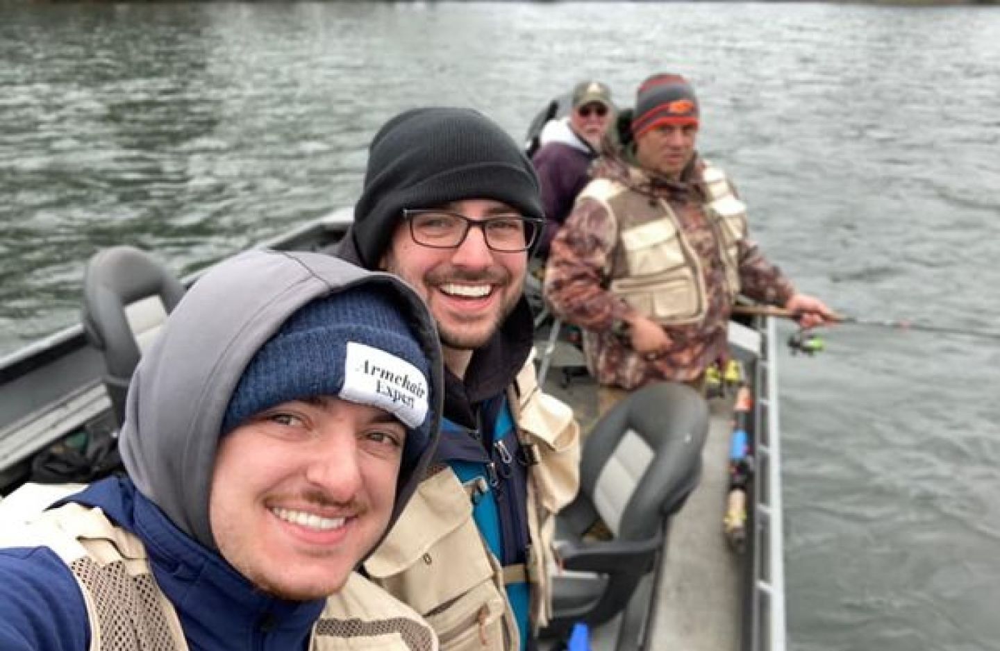 Fishing boat on water with multiple anglers during outdoor fishing trip