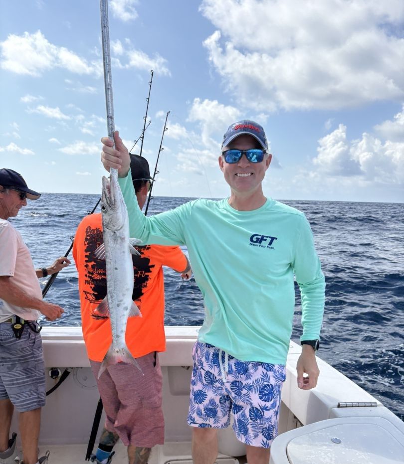 Two people fishing at an unknown location