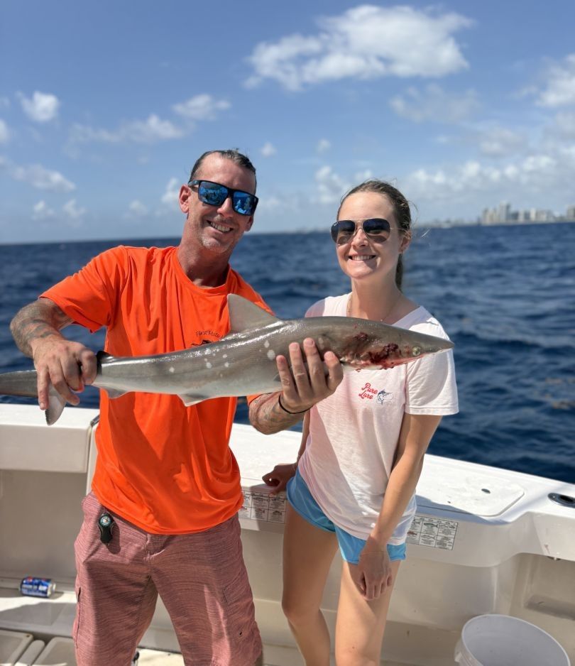 Two people fishing in unknown location