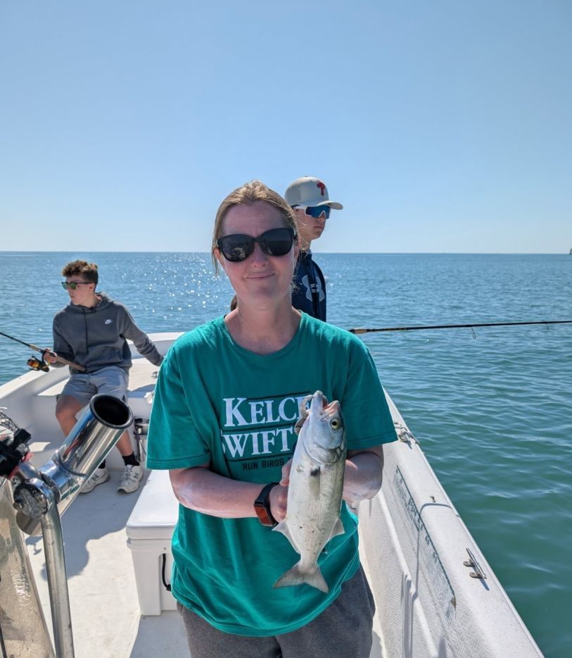3 people fishing in an unknown location