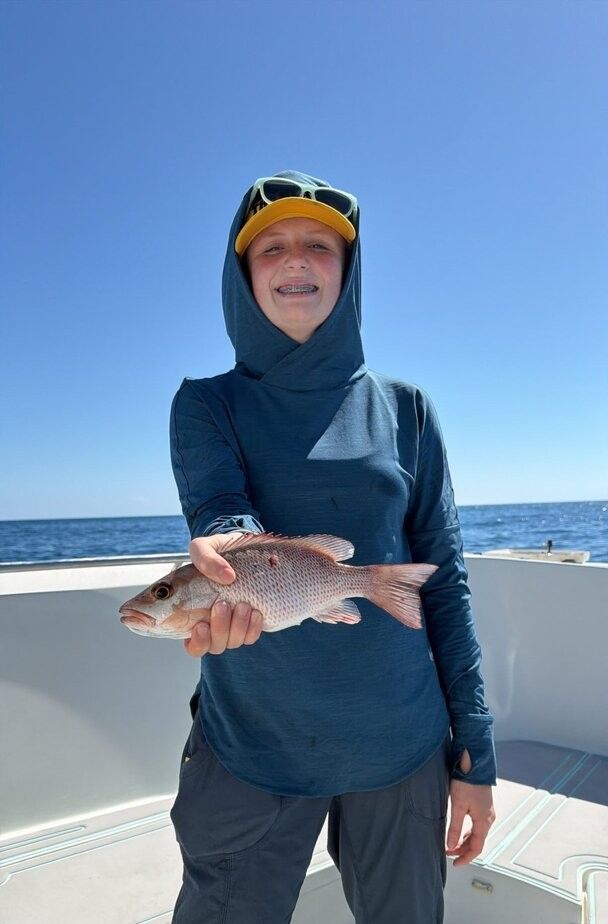 Grey snapper caught while fishing on boat in ocean