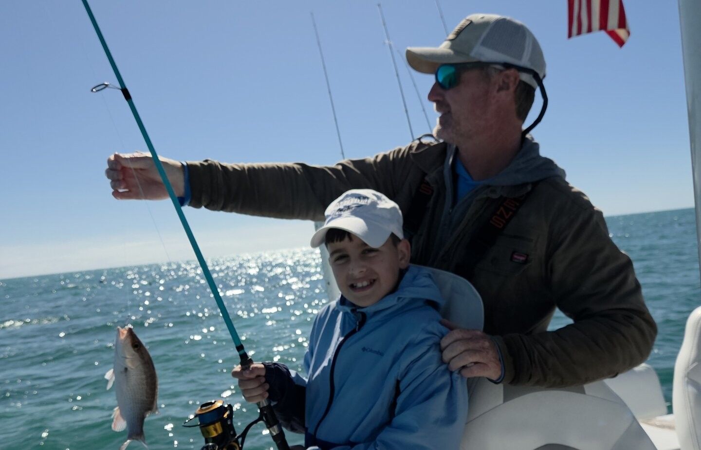 Grey snapper caught while fishing on boat in ocean waters