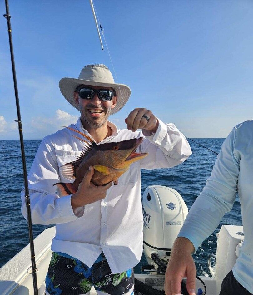 Hogfish catch displayed on fishing boat deck over ocean waters