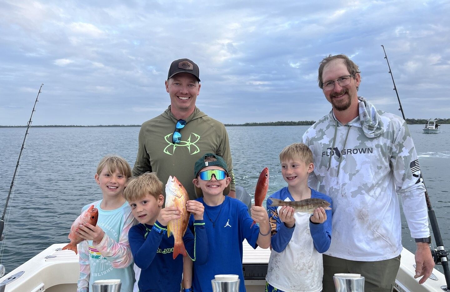 Successful fishing trip showing caught lane snapper and other fish on boat