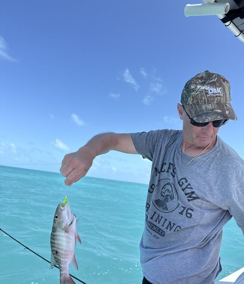 Mutton snapper caught while fishing on boat in clear blue water