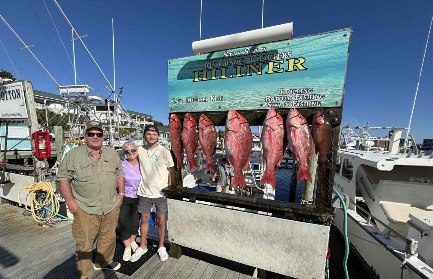 Red snapper fishing charter catch displayed on cleaning station at marina dock