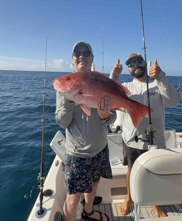 Red snapper caught on fishing boat with fishing rods visible on deck