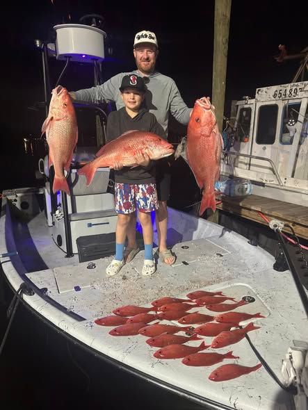 Successful fishing trip with red snapper and other fish displayed on boat deck