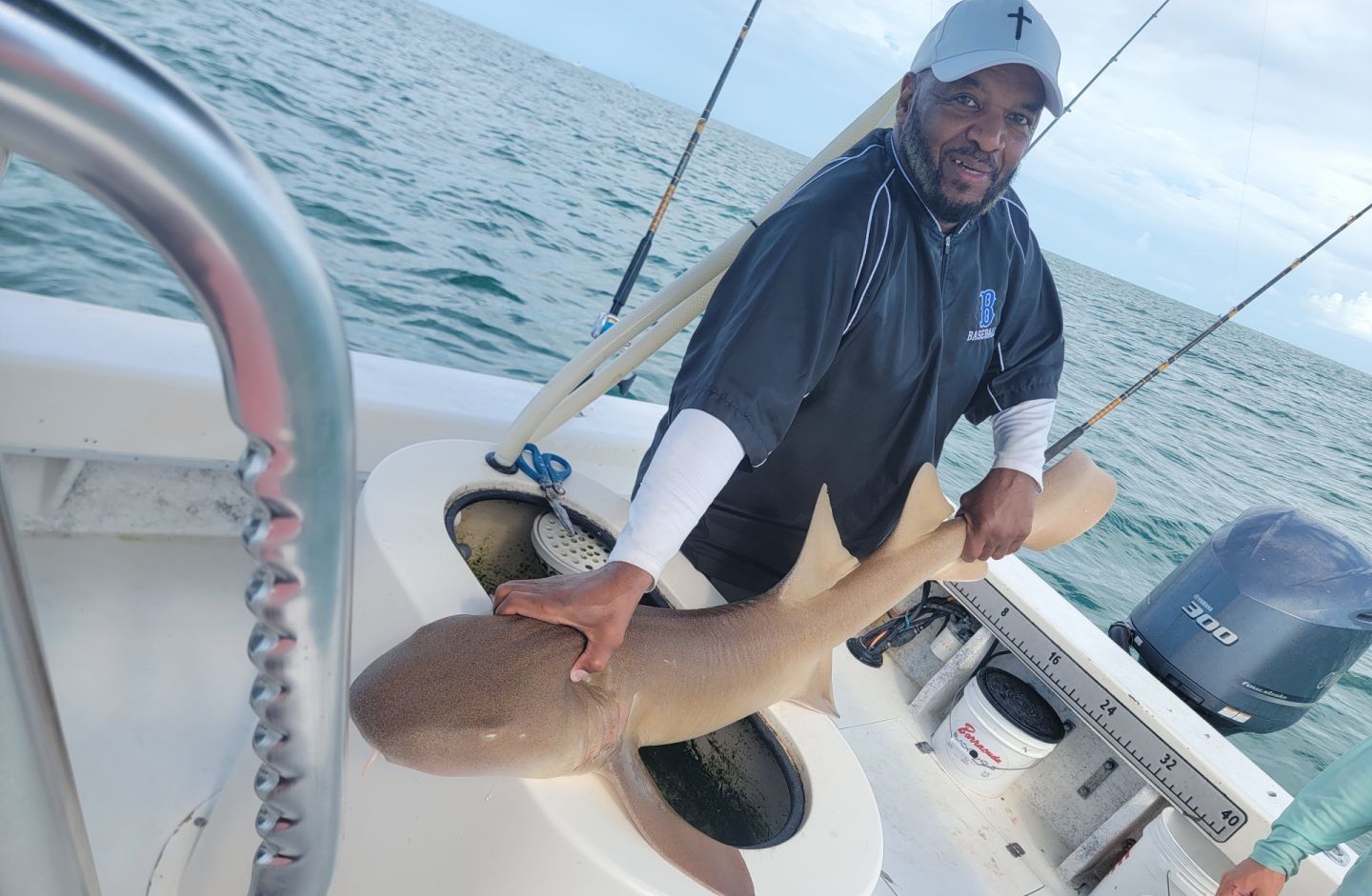 Large shark caught on fishing boat with measuring board showing size