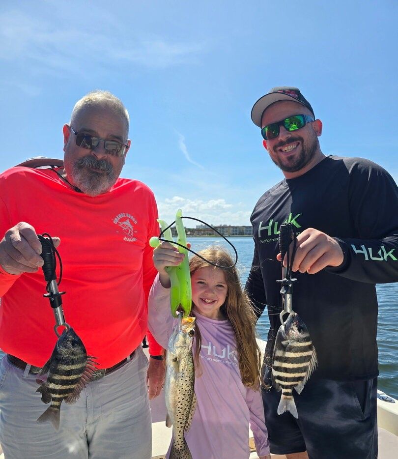 Successful fishing trip showing caught sheepshead and speckled trout on boat