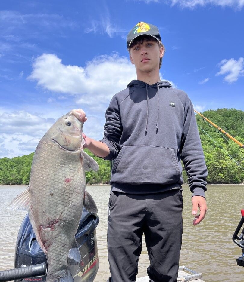 Freshly caught smallmouth buffalo being held up during a successful fishing trip