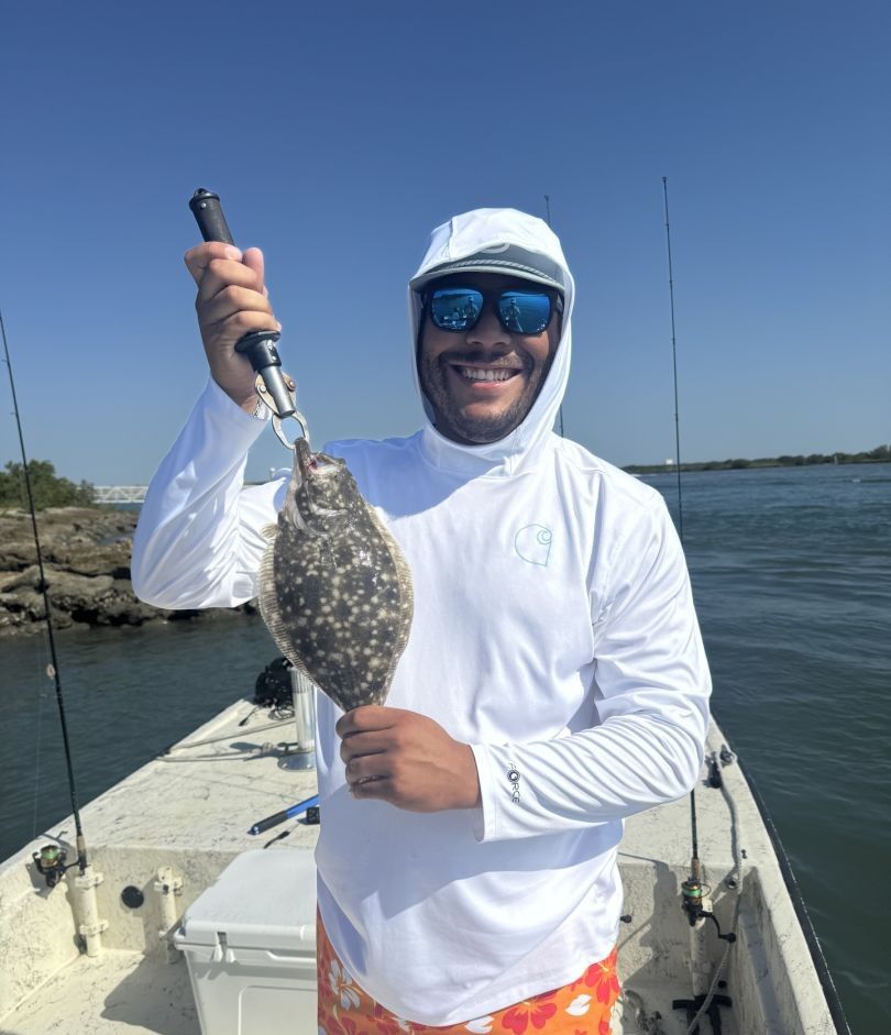 Southern flounder caught while fishing on boat in clear blue water