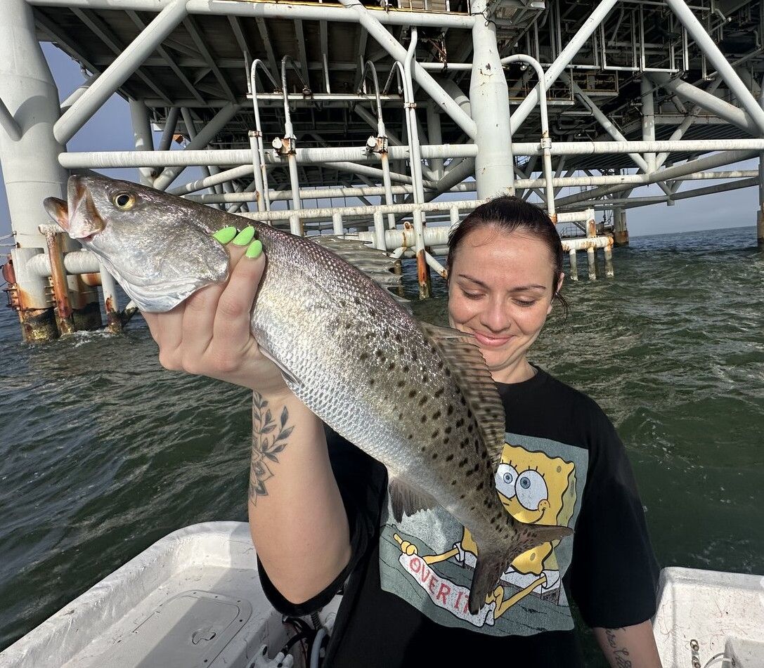 Large speckled trout catch displayed on fishing boat