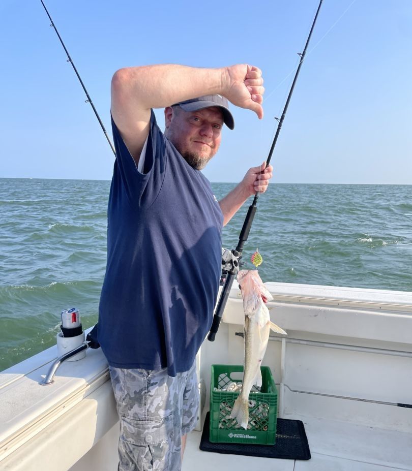 A person fishing in an unknown location