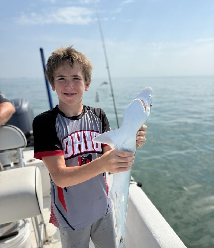 A person fishing in an unknown location