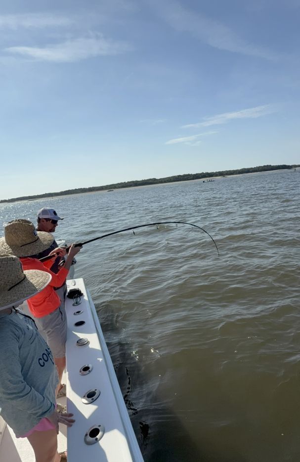 A person fishing in an unknown location