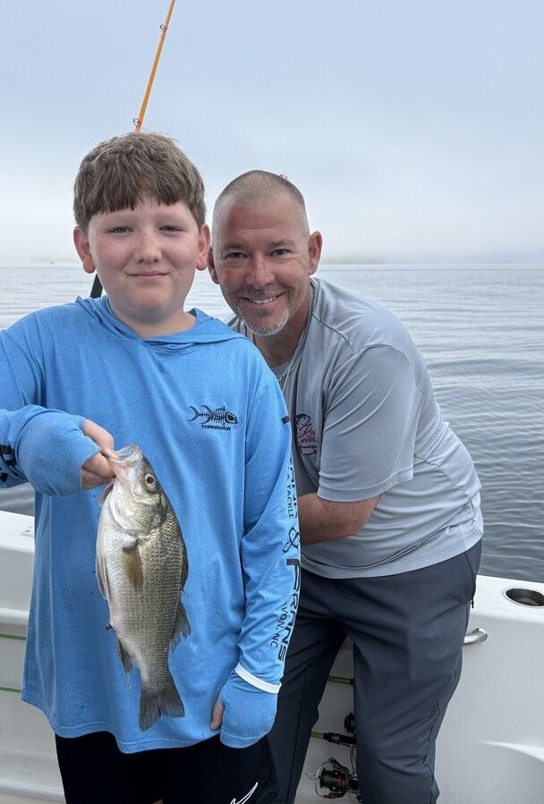 White perch catch displayed on fishing boat on water