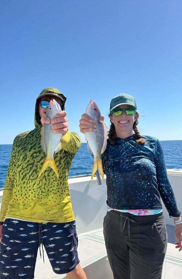 Two yellowfin fish caught during offshore fishing trip on boat deck