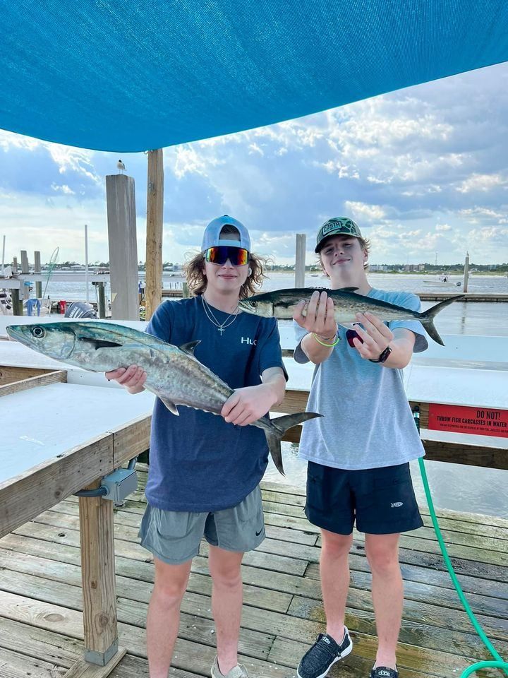 Two Spanish mackerel, each around 22 inches long, caught while fishing