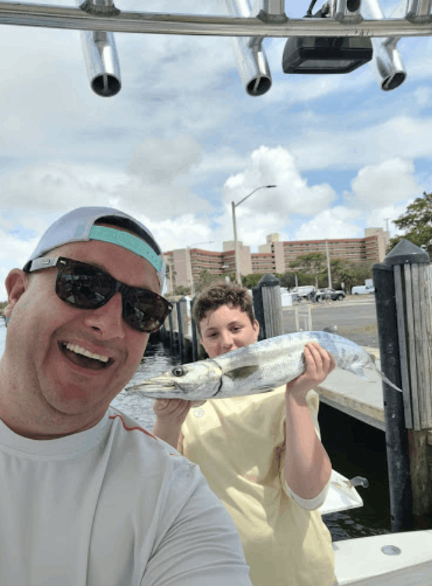 Two people fishing on an unknown body of water