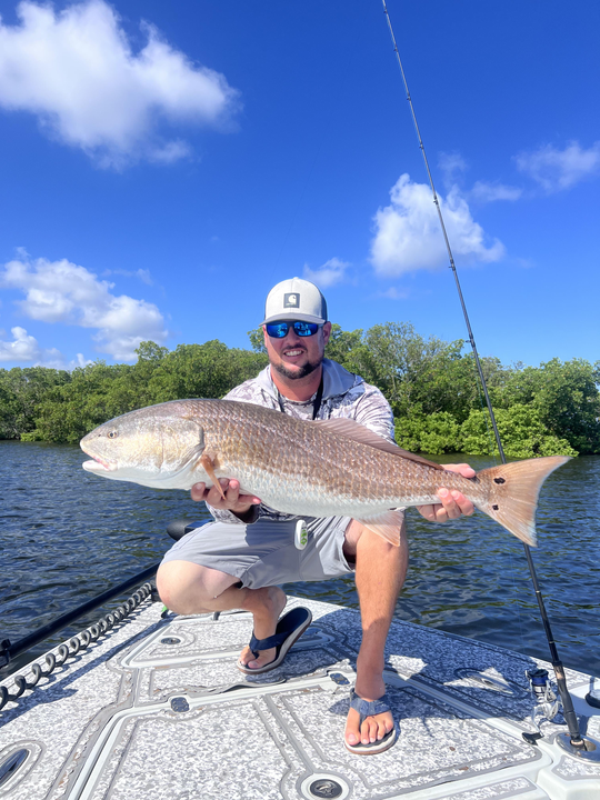 Huge 37-inch redfish reeled in on a partly cloudy day!