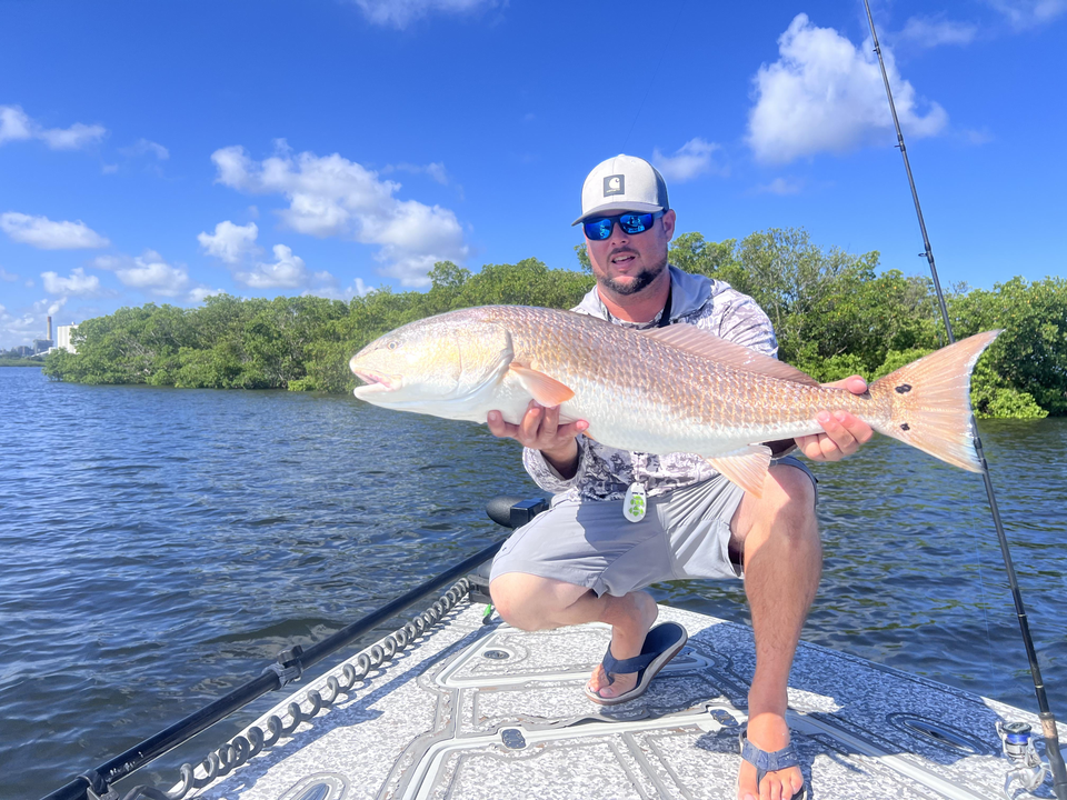 Huge 37-inch redfish landed during a stormy day adventure!