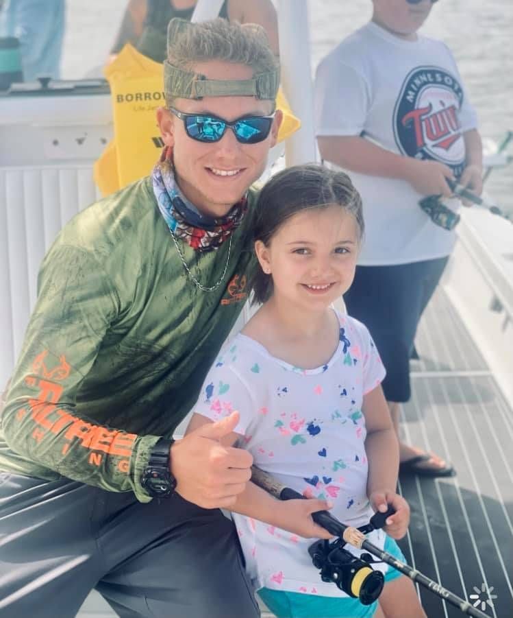 Two people fishing in a scenic location