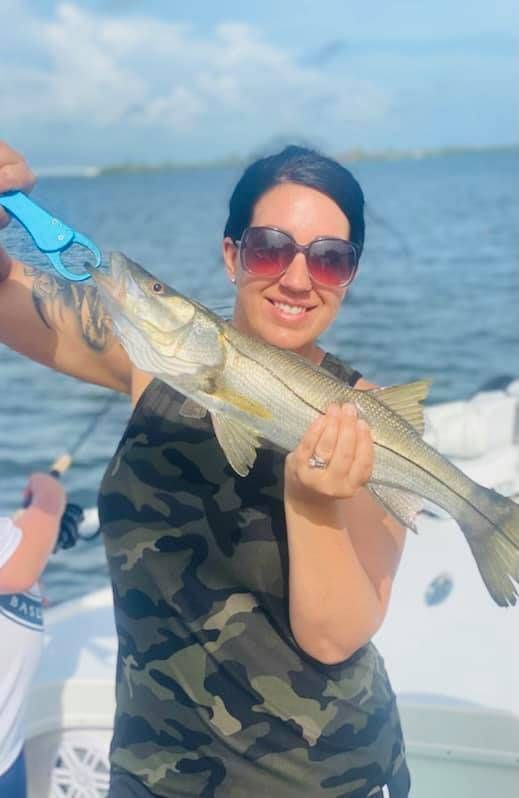 A Snook fish being caught during a fishing trip
