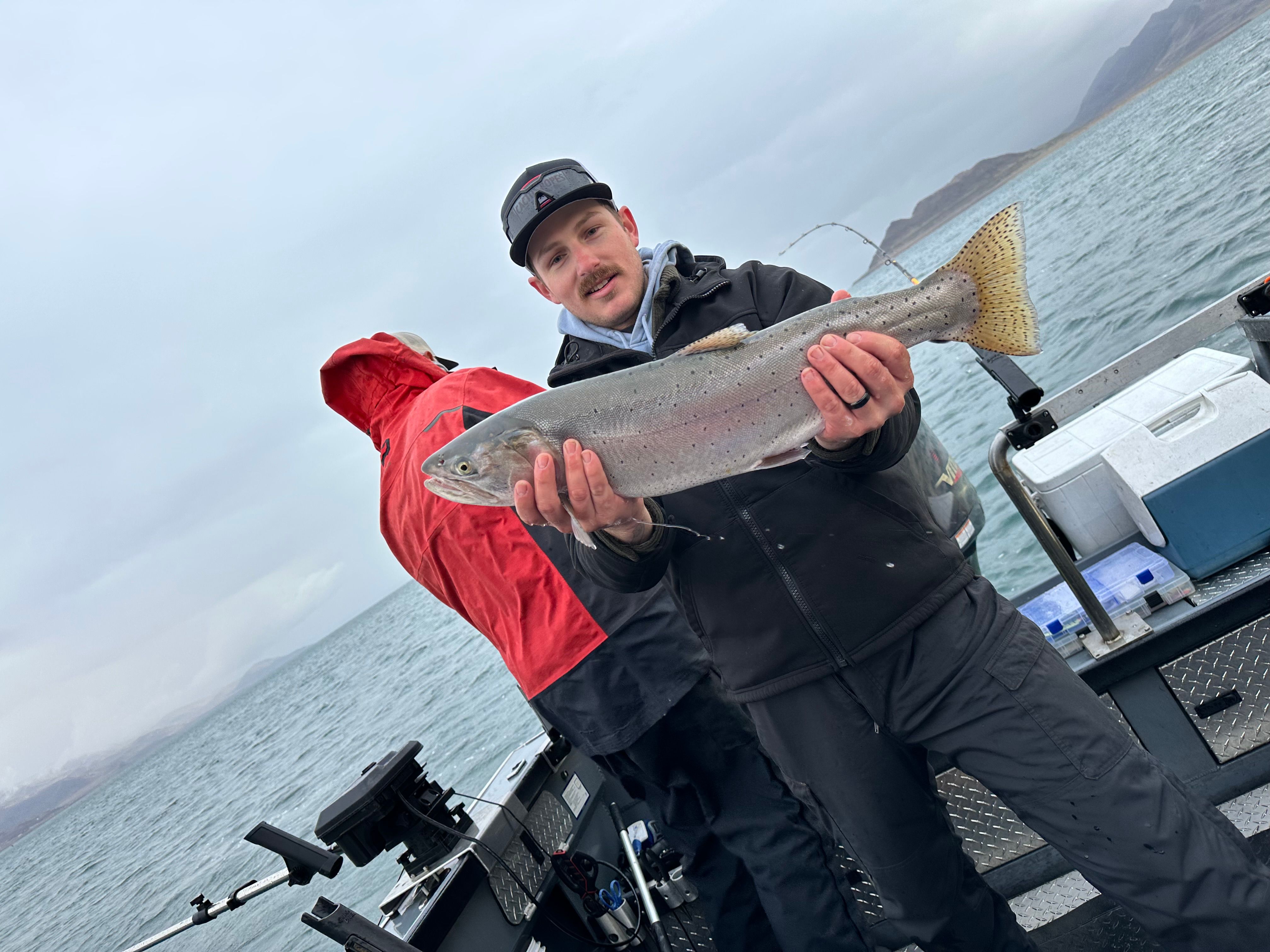 A person fishing in an unknown location