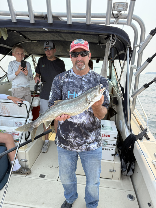 Reeling in a big lake trout while trolling at Knife River Marina!