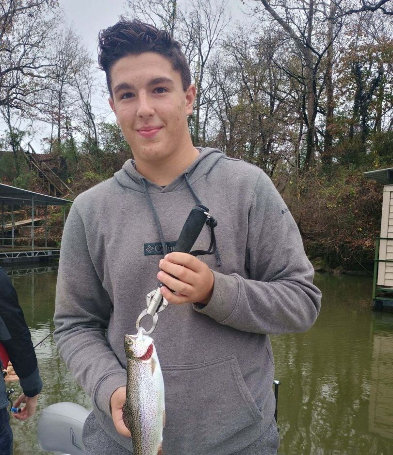 Catching a beautiful rainbow trout while fishing