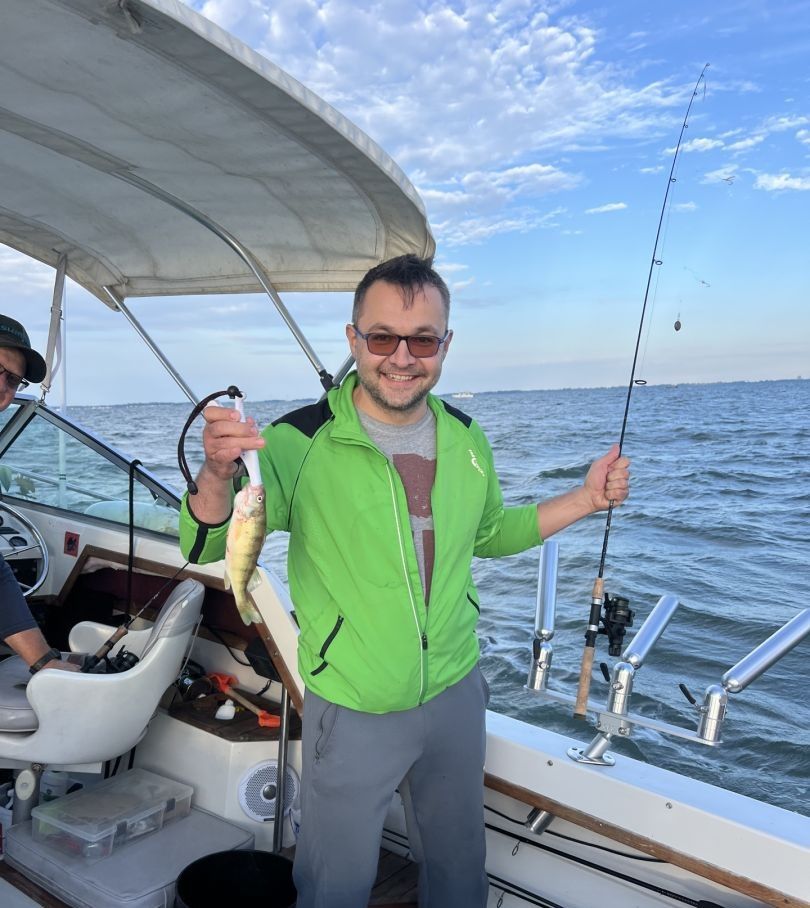 American Yellow Perch caught while fishing on boat with fishing rod and equipment visible