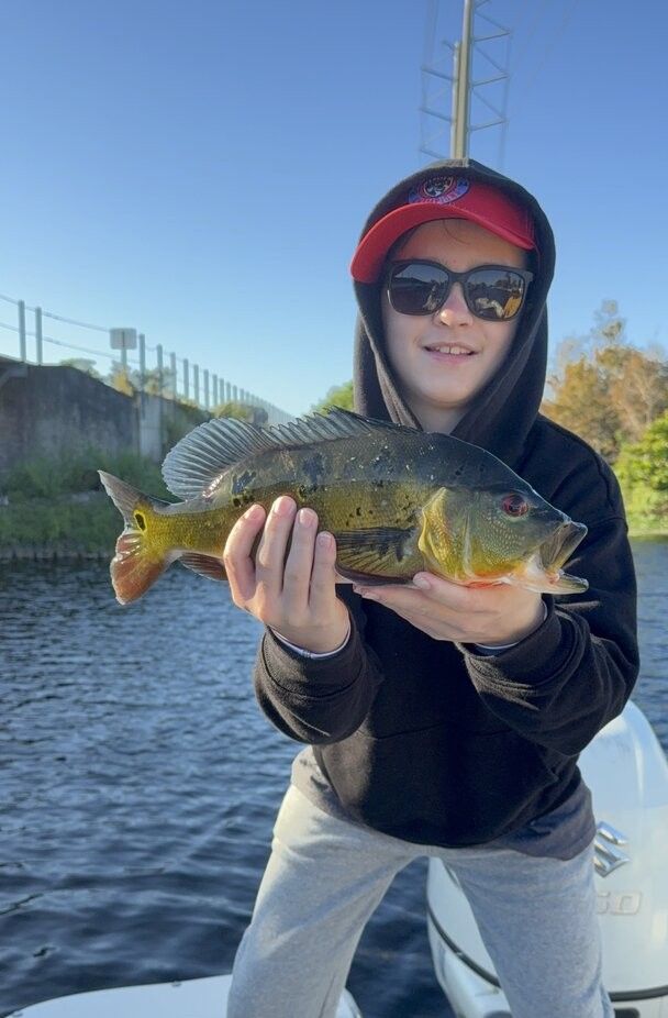 Fisherman standing at the water's edge, location unknown