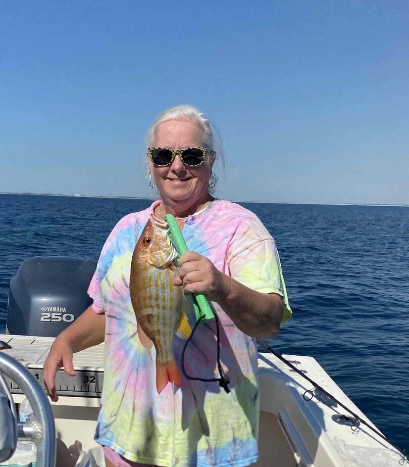 A person fishing in an unknown location