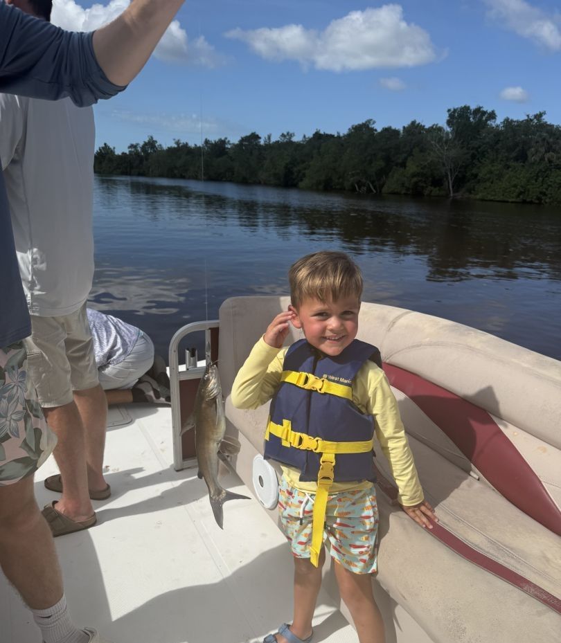 A person fishing in an unknown location