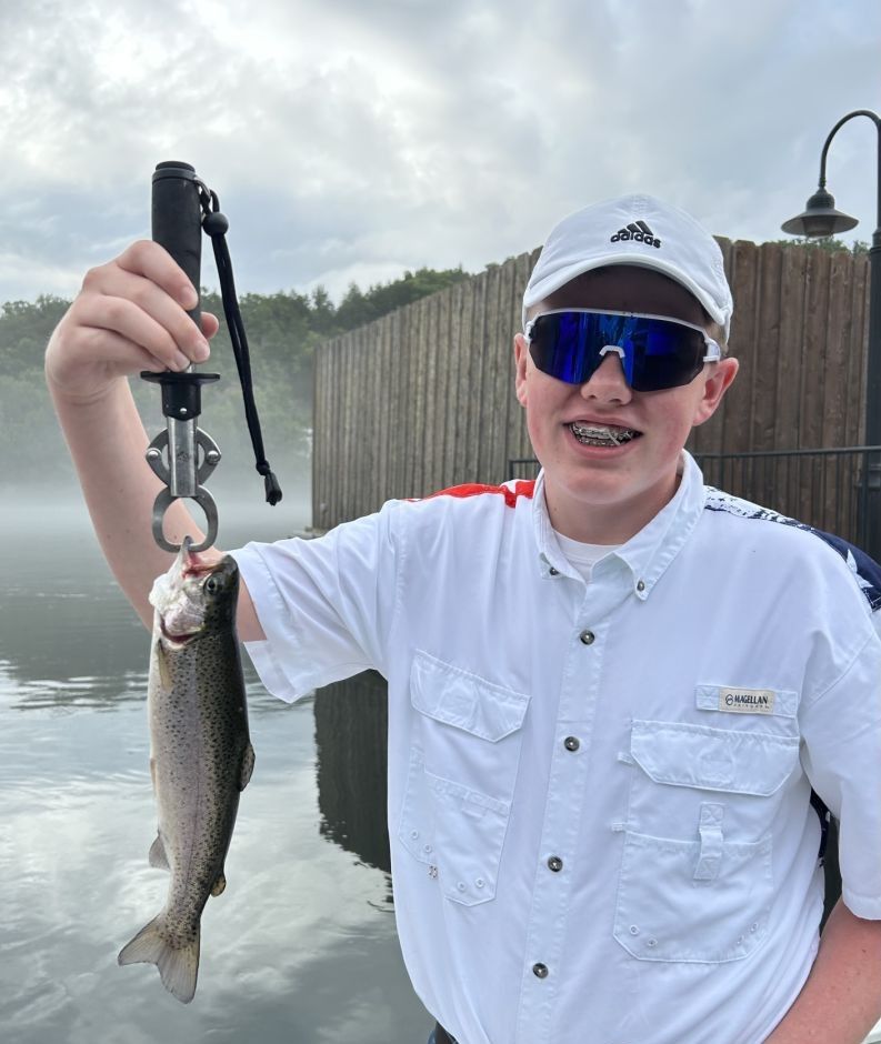 Angler with a rainbow trout fish