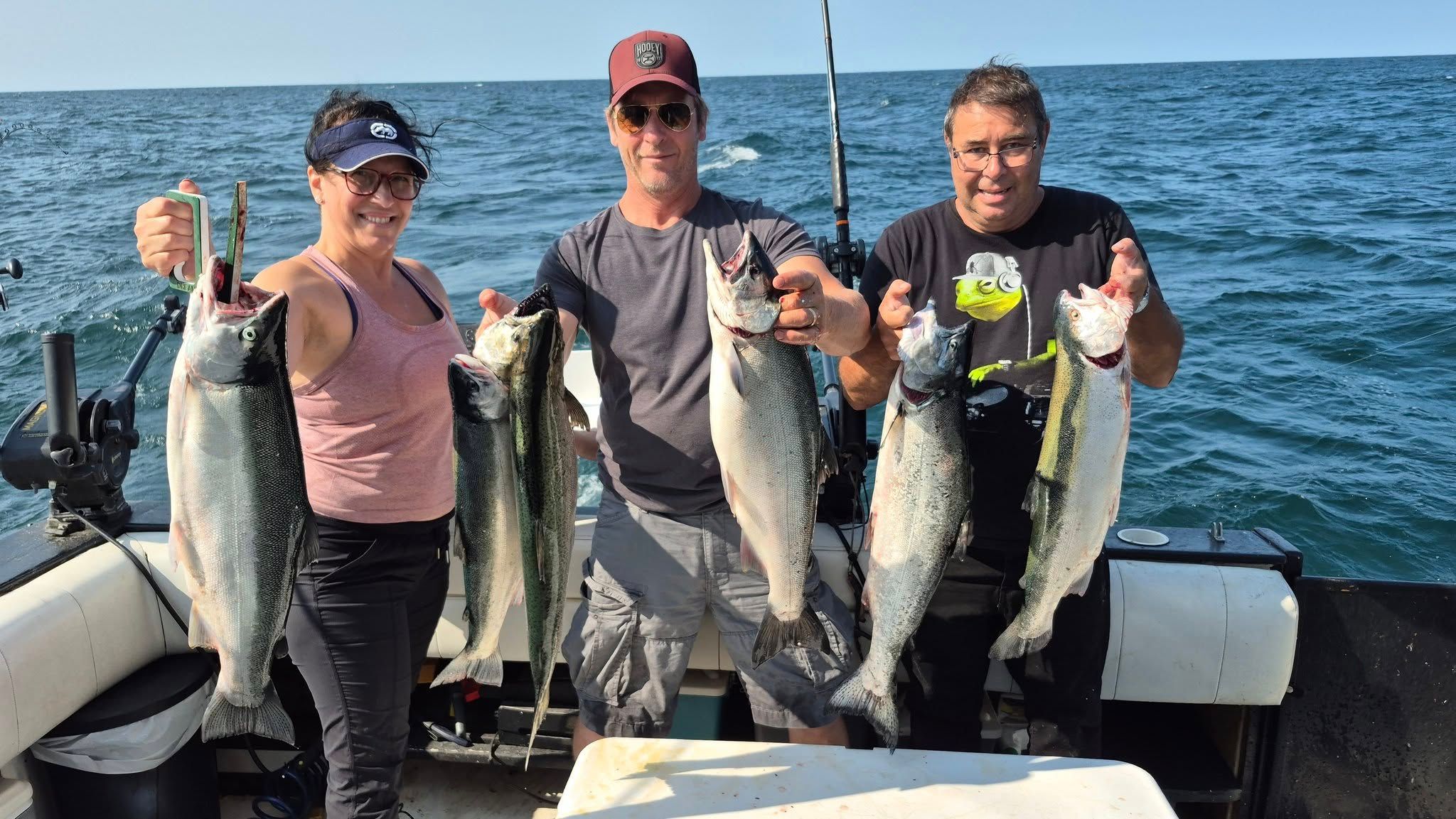 Three anglers fishing for coho salmon, rainbow trout, and lake trout