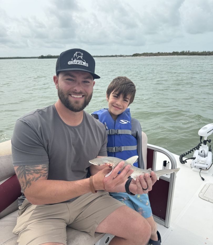 Two people fishing at an unknown location