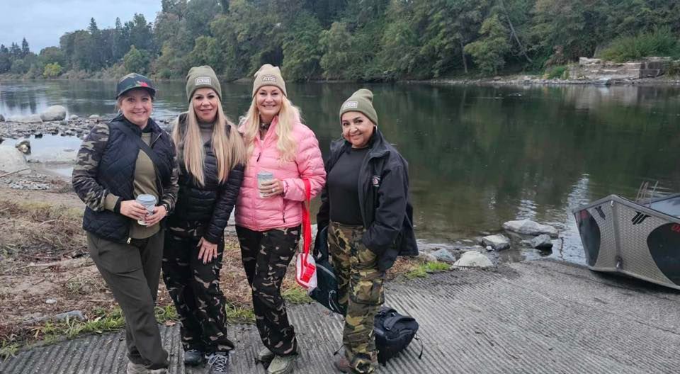 A group of 4 people fishing at an unknown location