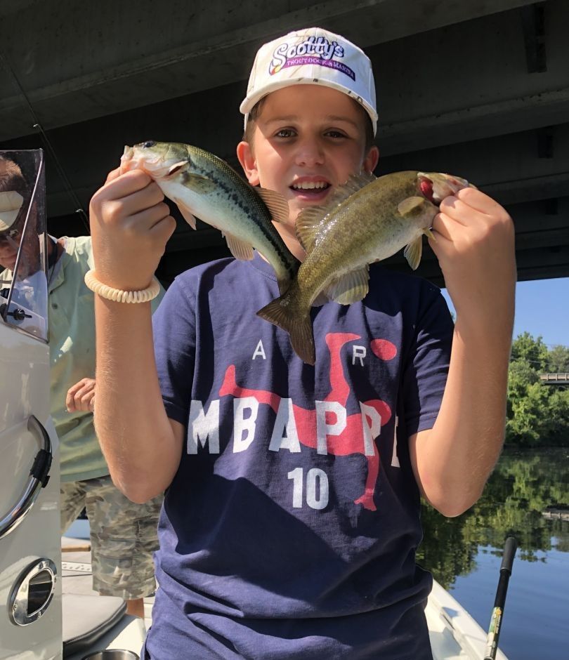 Angler with two largemouth bass fish