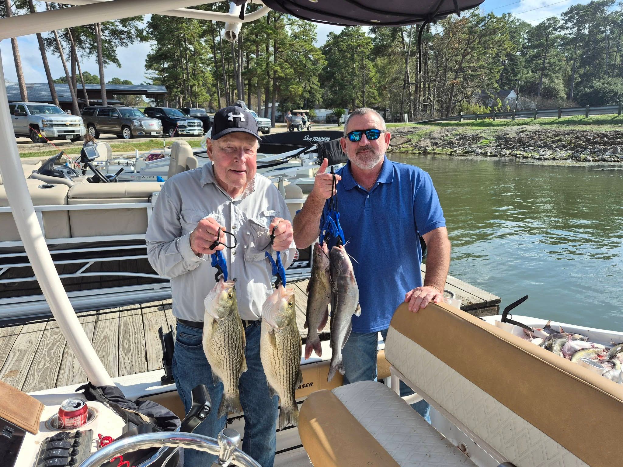 Two anglers with 3 wiper and channel catfish in an unknown location