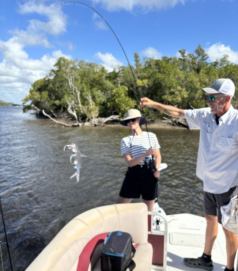 Two people fishing at an unknown location