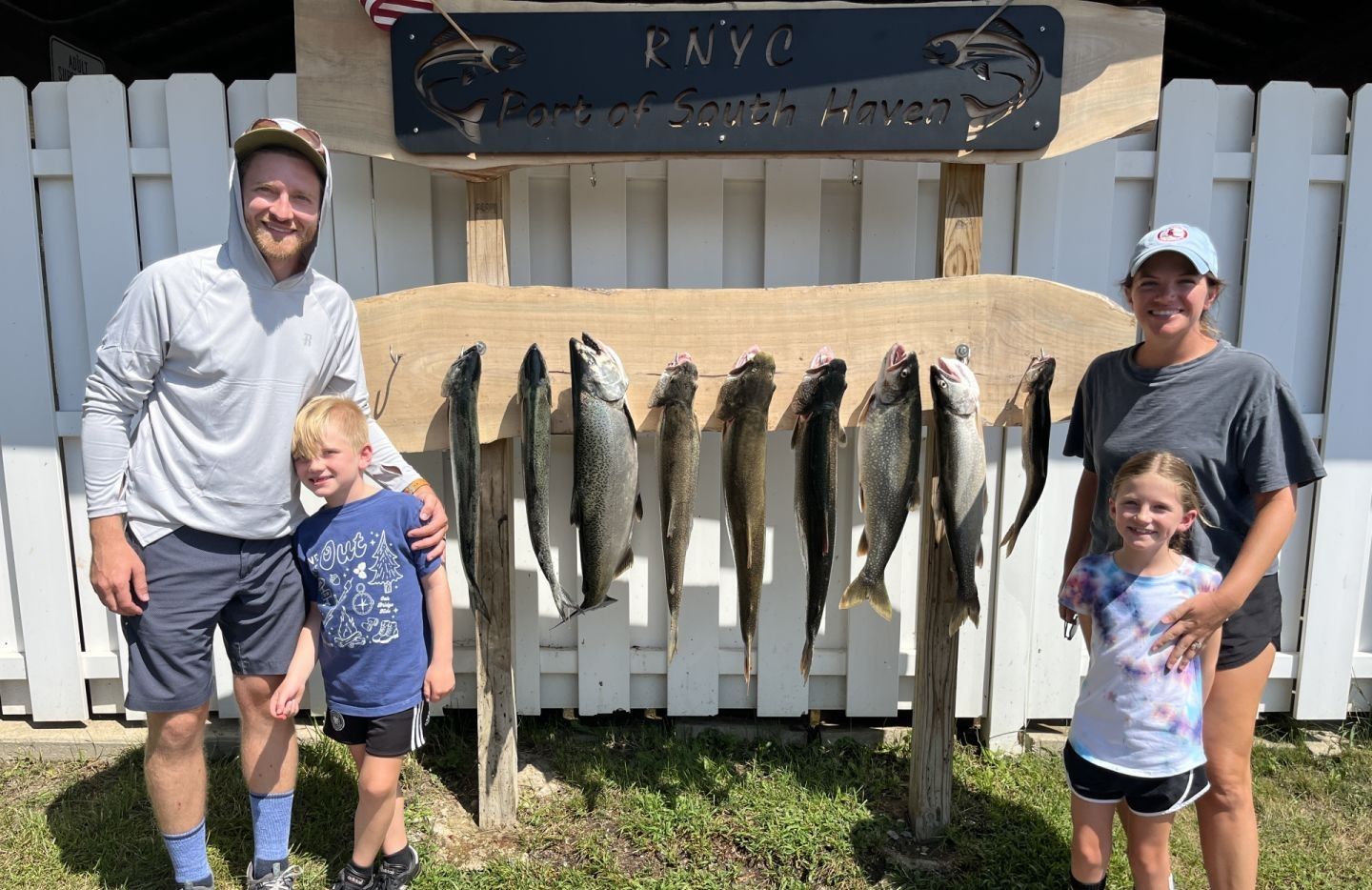 A group of 4 people fishing for 5 great barracuda in an unknown location.