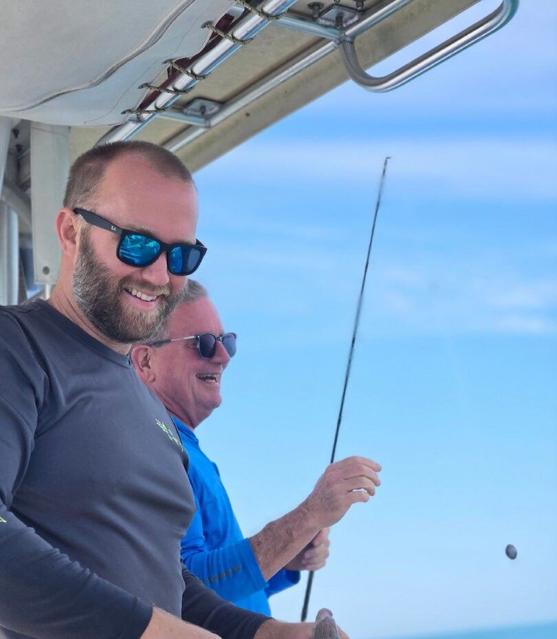 Two anglers enjoying a day of fishing at an unknown location