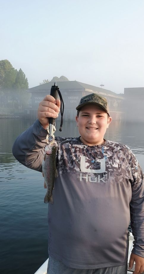 A rainbow trout being caught while fishing