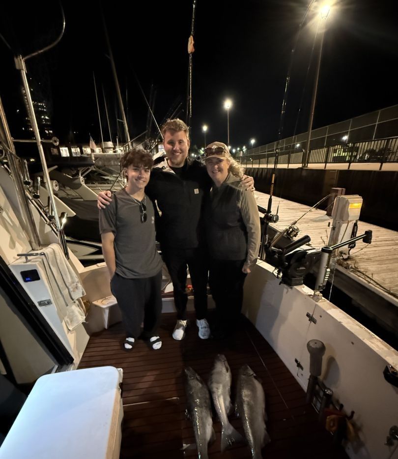 3 people fishing on the water